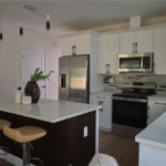 Plan 0112 by HeLo Homes – kitchen with island and white cabinets